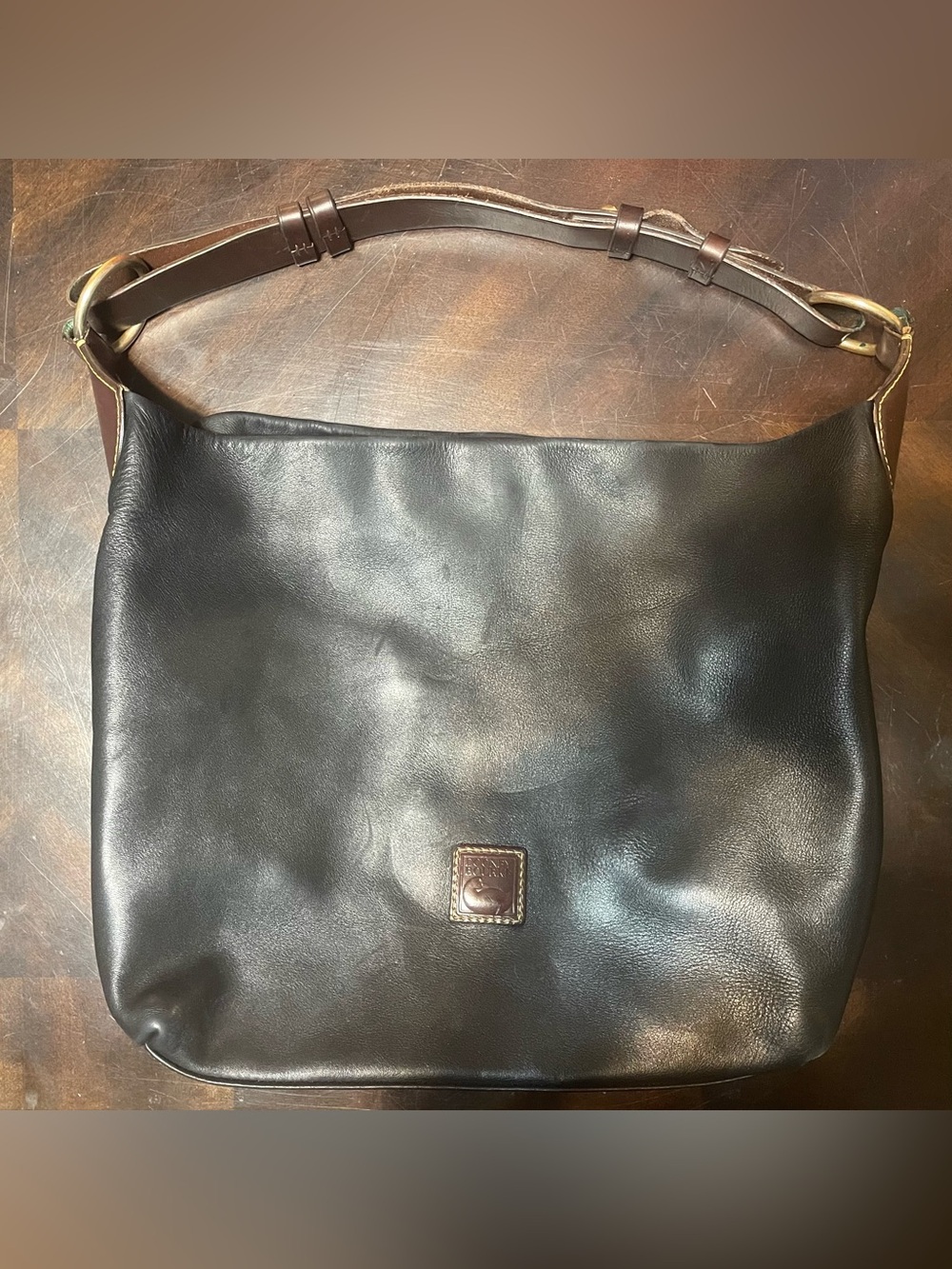 Dooney & Bourke Black Leather shoulder Bag with Brown leather strap